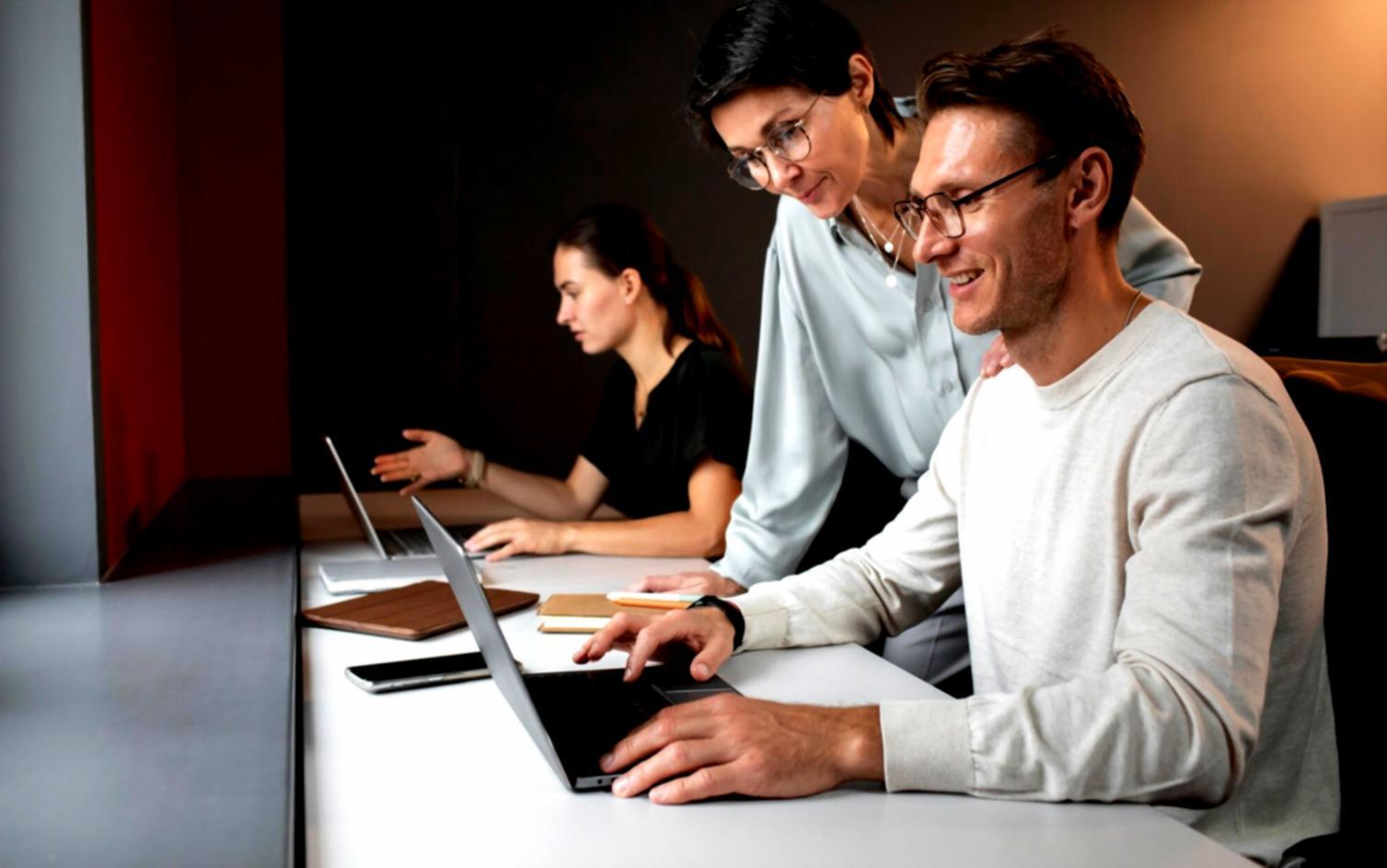 Students collaborating on budget planning exercises in workshop environment